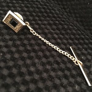 Gold-toned tie pin with chain